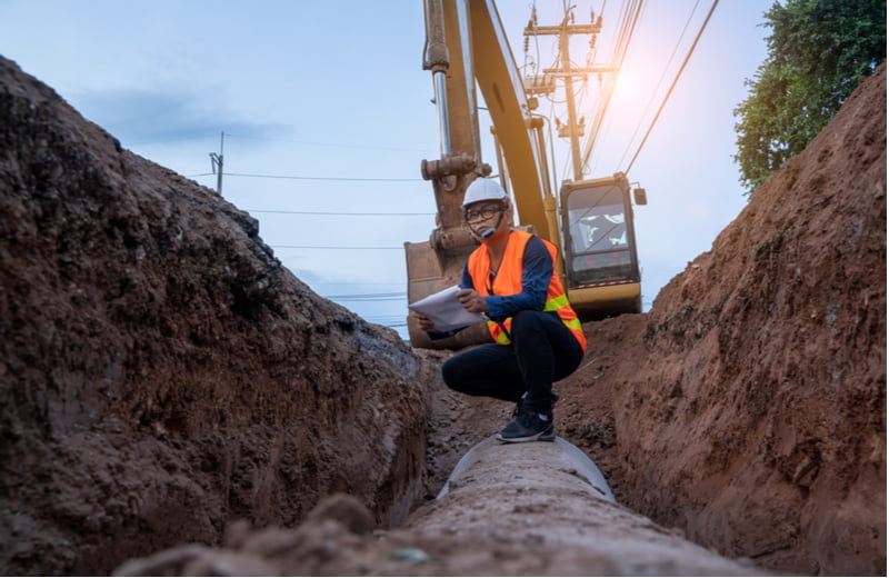 Engineer wear safety uniform examining excavation water supply