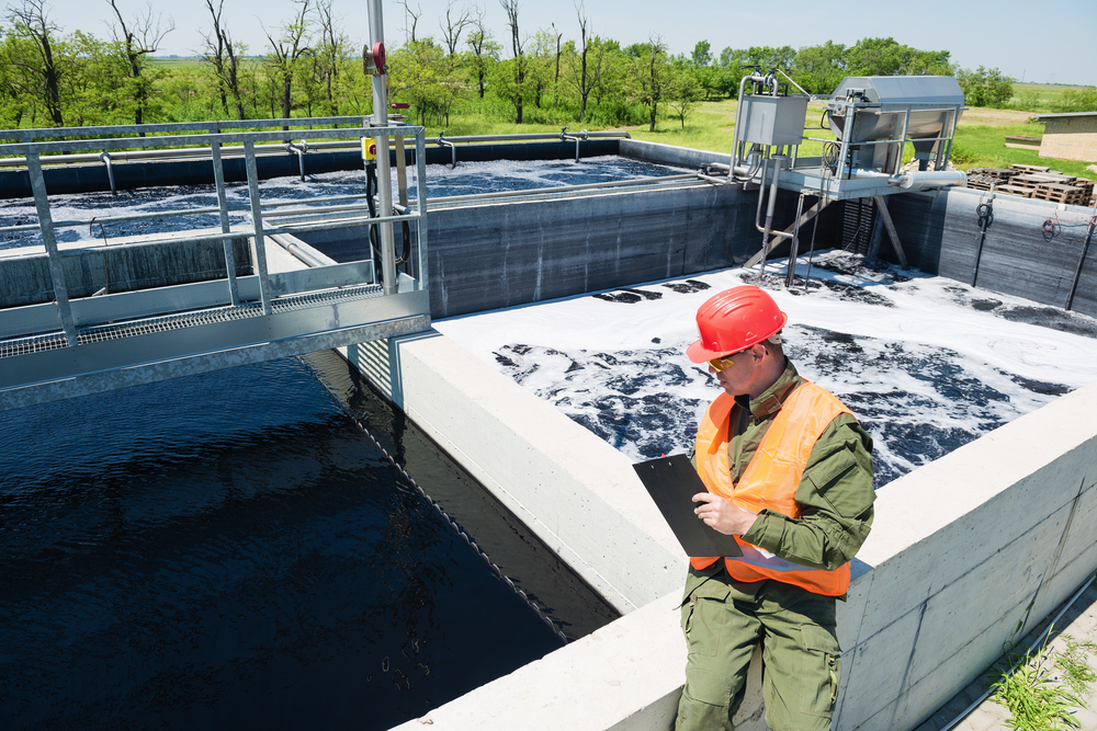 An engineer controlling a quality of water ,aerated activated sludge tank at a waste water treatment plant